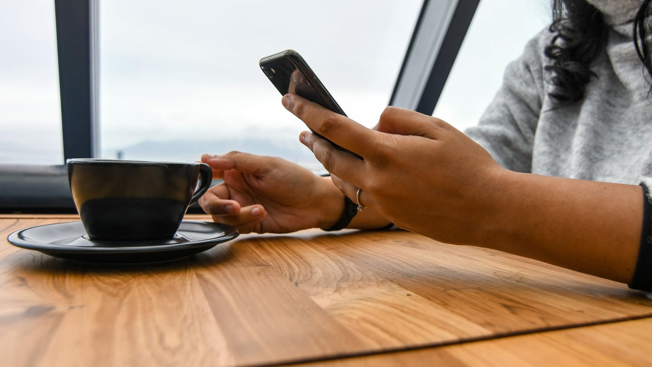 a woman sitting at a table using a laptop