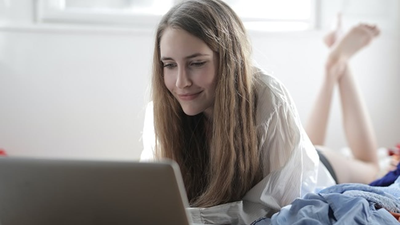 a woman sitting in front of a laptop