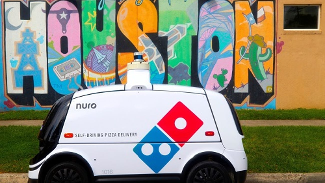 a car parked in front of a graffiti covered wall