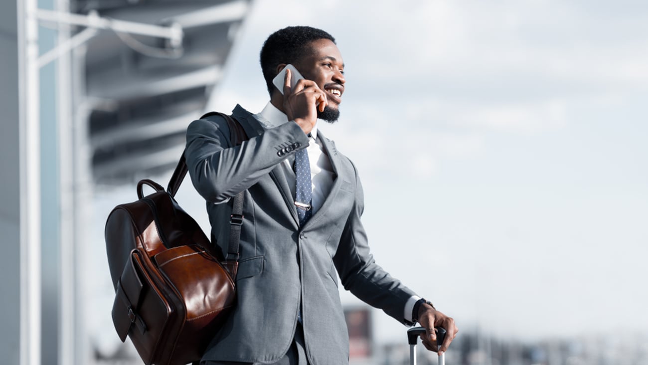 a man wearing a suit and tie talking on a cell phone