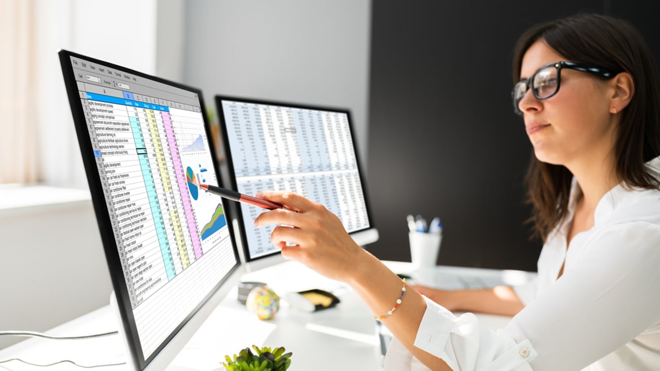 Woman looking at a spreadsheet on a computer screen