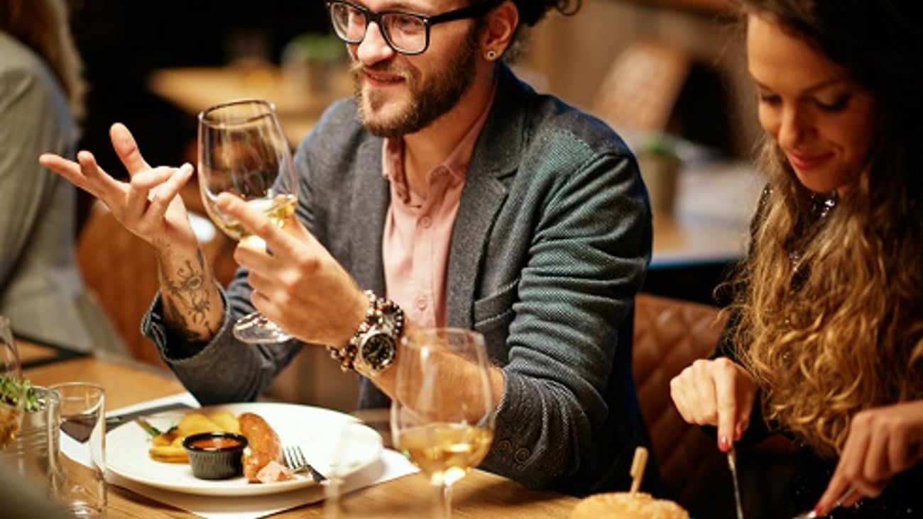 hipster guy with man bun drinking wine