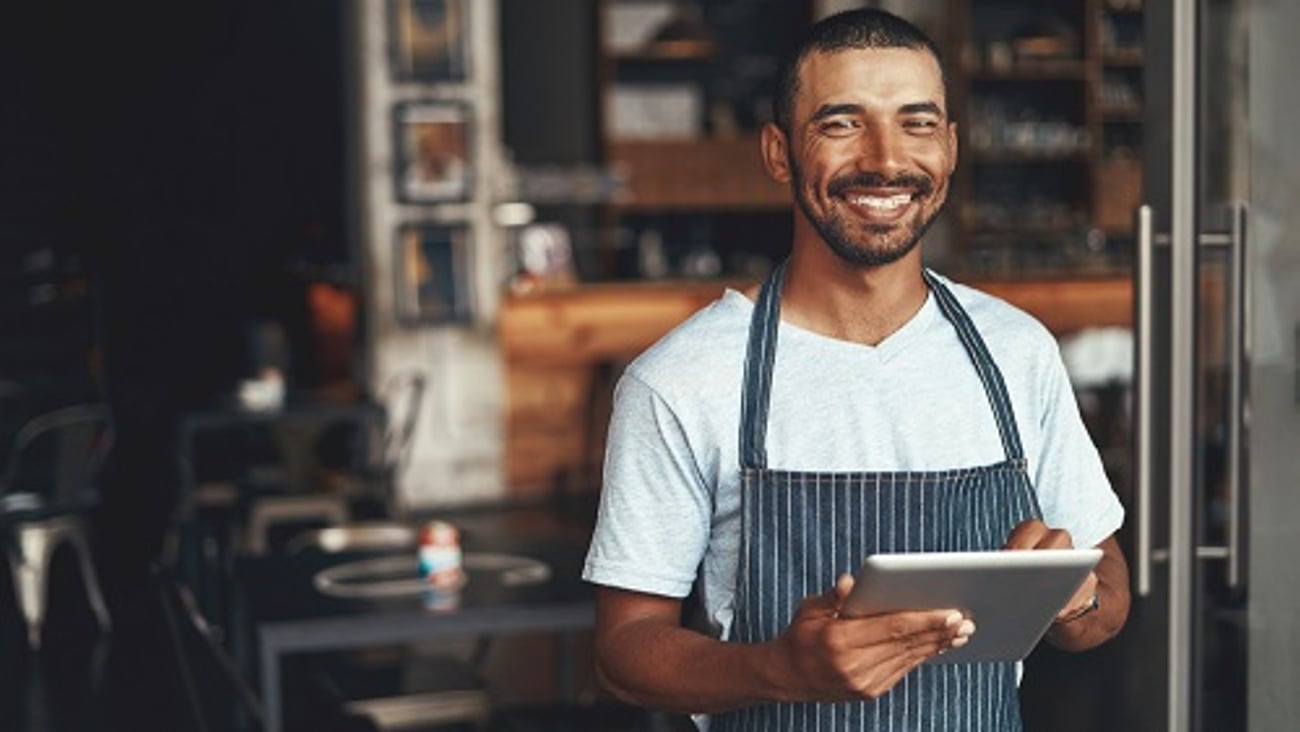 male restaurant owner staff with tablet