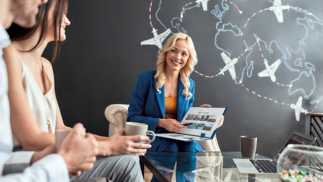 travel agent working with a couple to make vacation plans