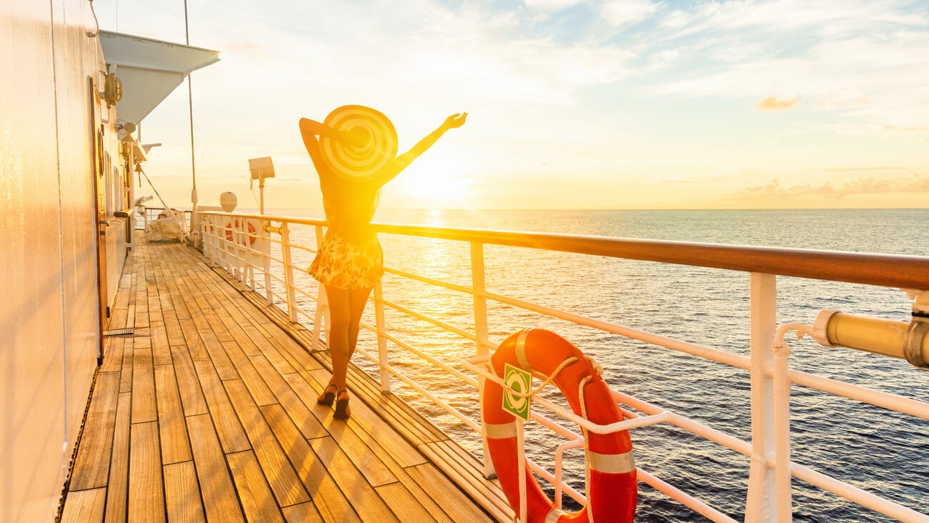 Luxury cruise ship travel elegant woman having fun carefree on deck enjoying watching sunset on Europe cruising destination vacation. Summer european mediterranean cruiseship sailing away on holiday.; Shutterstock ID 1551356090
