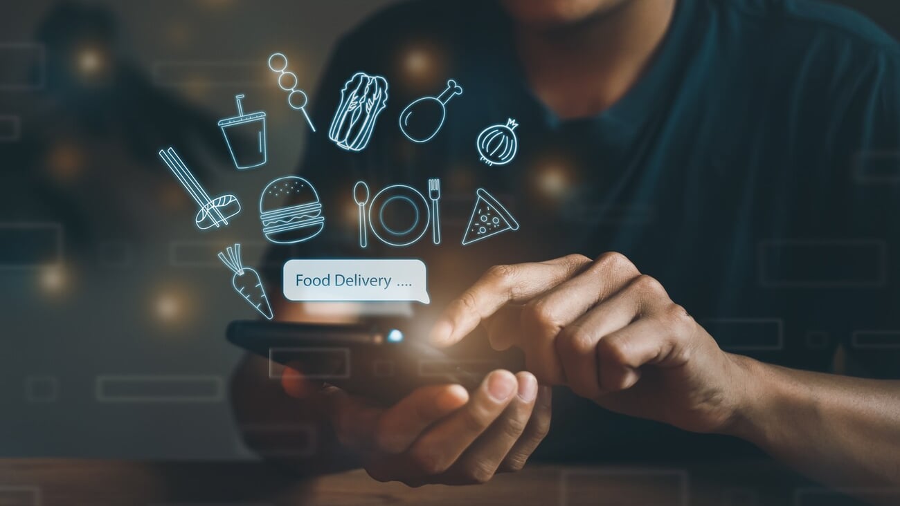 People use mobile phones to place online restaurant orders, delivery, technology, internet, food burger icons, pizza, coffee, chicken, sushi, vegetables, noodles, service meal food menu online at home; Shutterstock ID 2171819655