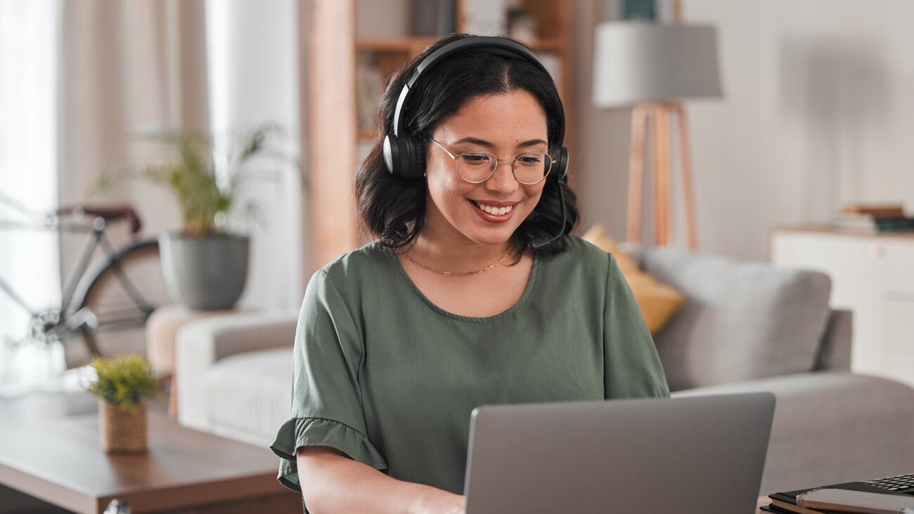 Happy, remote work and woman with a laptop for call center communication and consultation. Smile, virtual assistant and a customer service agent typing on a computer from a house for telemarketing; Shutterstock ID 2337392717