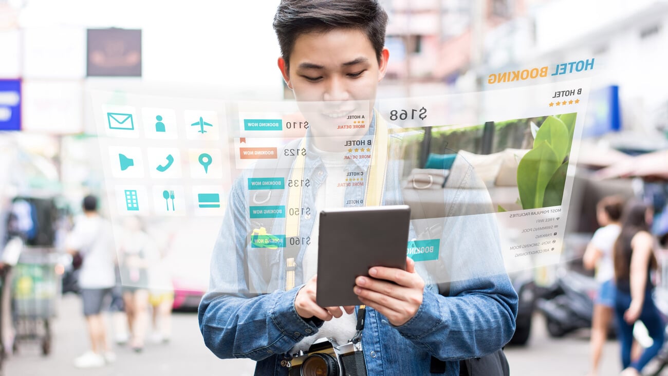 Asian tourist backpacker using mobile appication technology booking hotel online while traveling on vacations,  selective focus; Shutterstock ID 1105703327