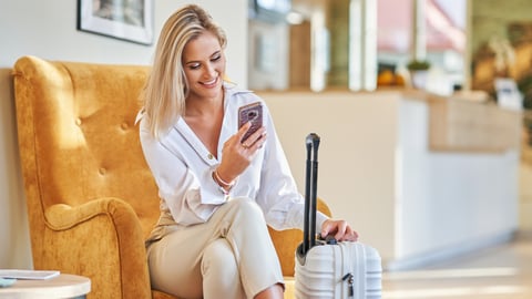 a woman sitting in a chair talking on the phone