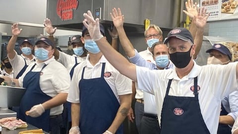 a group of people preparing food in a kitchen