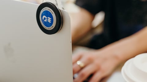 a person using a laptop computer sitting on top of a table