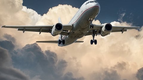 a large passenger jet flying through a cloudy sky