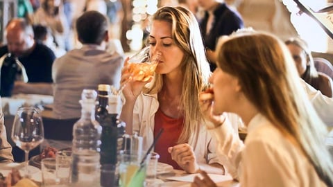 a group of people sitting at a table with wine glasses