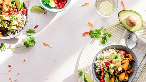 a bowl of salad on a plate on a table