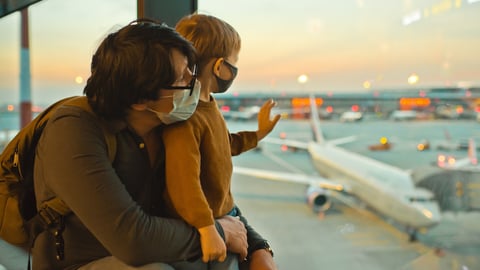 a woman sitting on a tarmac at an airport