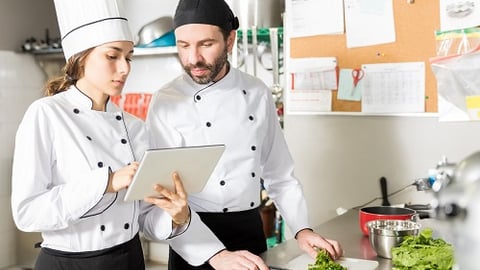 a person standing in a kitchen preparing food