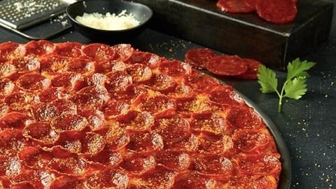 a pizza sitting on top of a pan on a stove