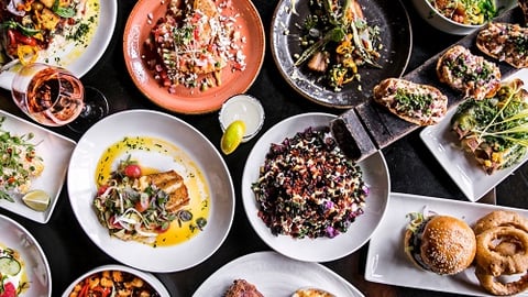 a bowl filled with many different types of food on a table