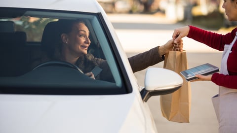 a person sitting in front of a mirror in a car