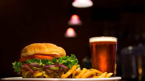 a plate of food and a glass of beer on a table