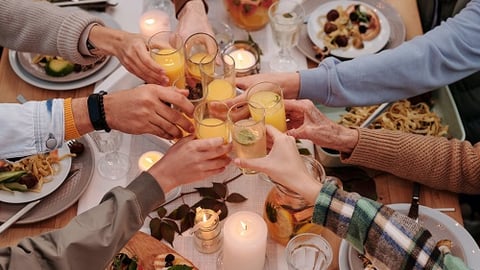 a group of people sitting at a table eating food