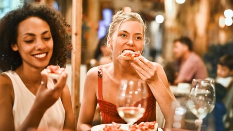 a group of people sitting at a table in a restaurant