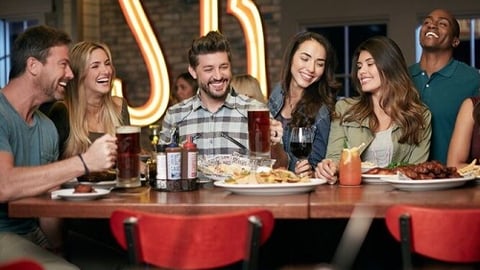 a group of people sitting at a table in a restaurant