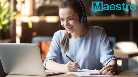 a person sitting at a table using a laptop