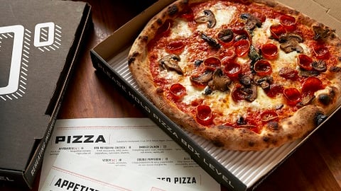 a pizza sitting on top of a wooden table