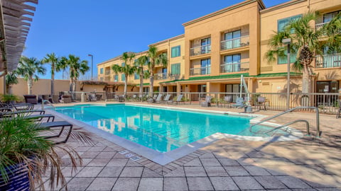 a pool in front of a brick building