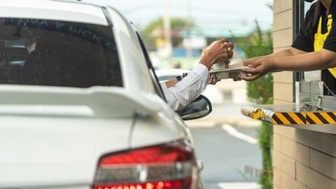 a person riding on the back of a car