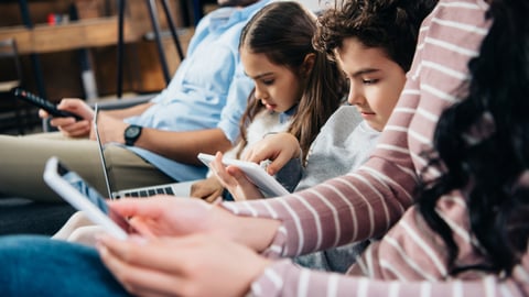 a group of people looking at a laptop