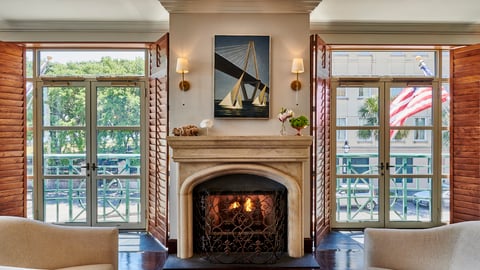 a fireplace in a living room filled with furniture and a fire place