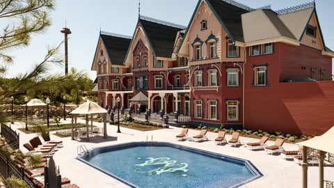 a house with a pool in front of a building