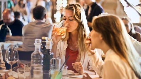 a group of people sitting at a table with wine glasses