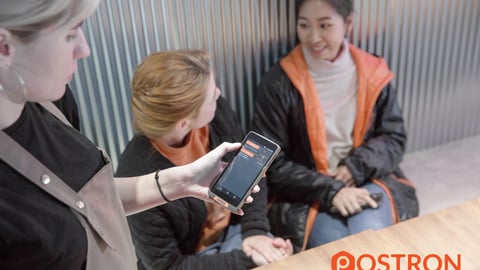 a group of people looking at a phone