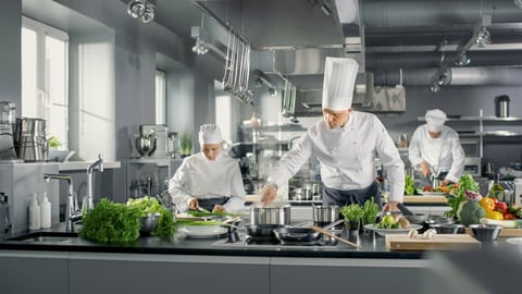 a person cooking in a kitchen preparing food