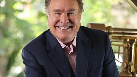 Richard D. Fain wearing a suit and tie smiling at the camera