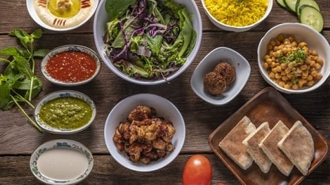 a bowl of food on a wooden table