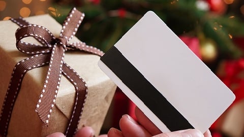 a hand holding a gift card