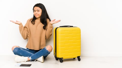 a woman sitting on a suitcase