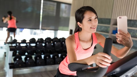 Women in hotel gym taking selfie