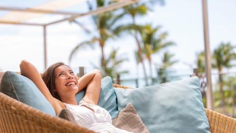 woman relaxing outside hotel room