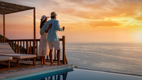 Man and woman on vacation watching sunset