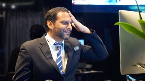 frustrated hotel manager in front of computer