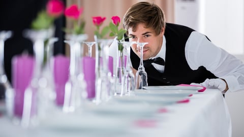 Hotel waiter working on tables