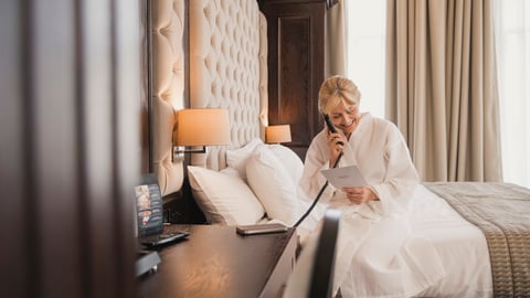 woman on telephone in hotel room