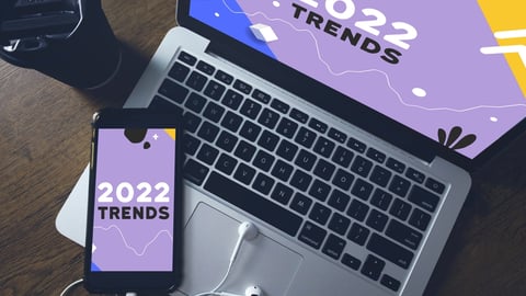 Laptop and cell phone with 2022 trends written on them