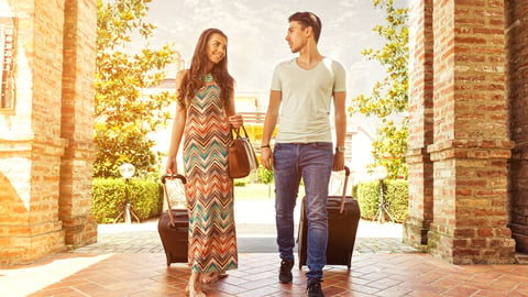 Travelers entering a hotel lobby