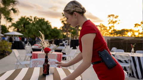 Woman decorating outdoor table with walkie talkie